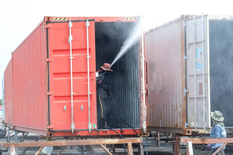 Washing out shipping containers on a contained site
