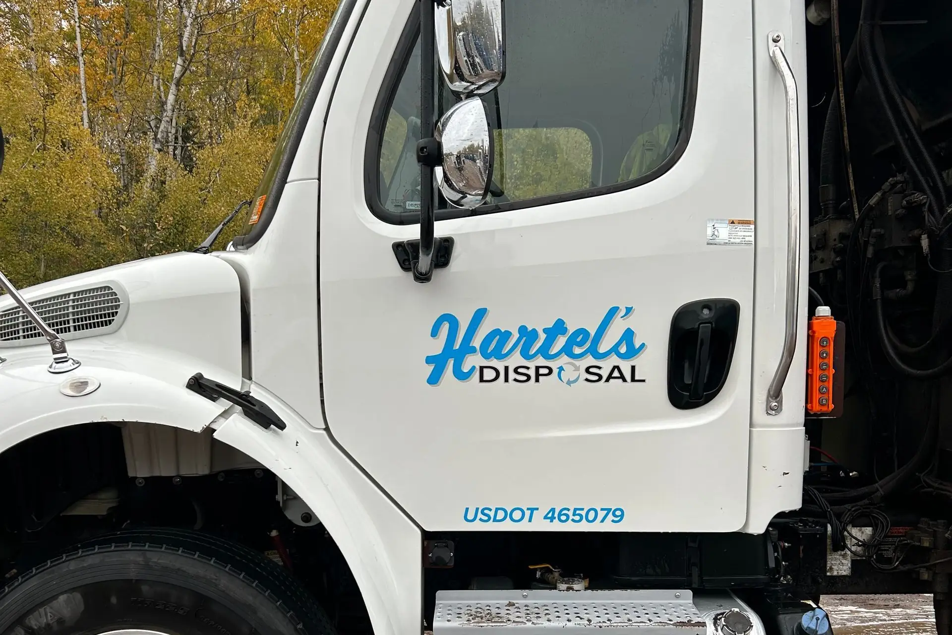 A freshly washed refuse truck cab in a customer's yard, washed on site by The Mobile Wash Company